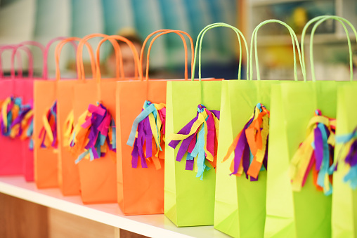 Colorful shopping bags standing in row